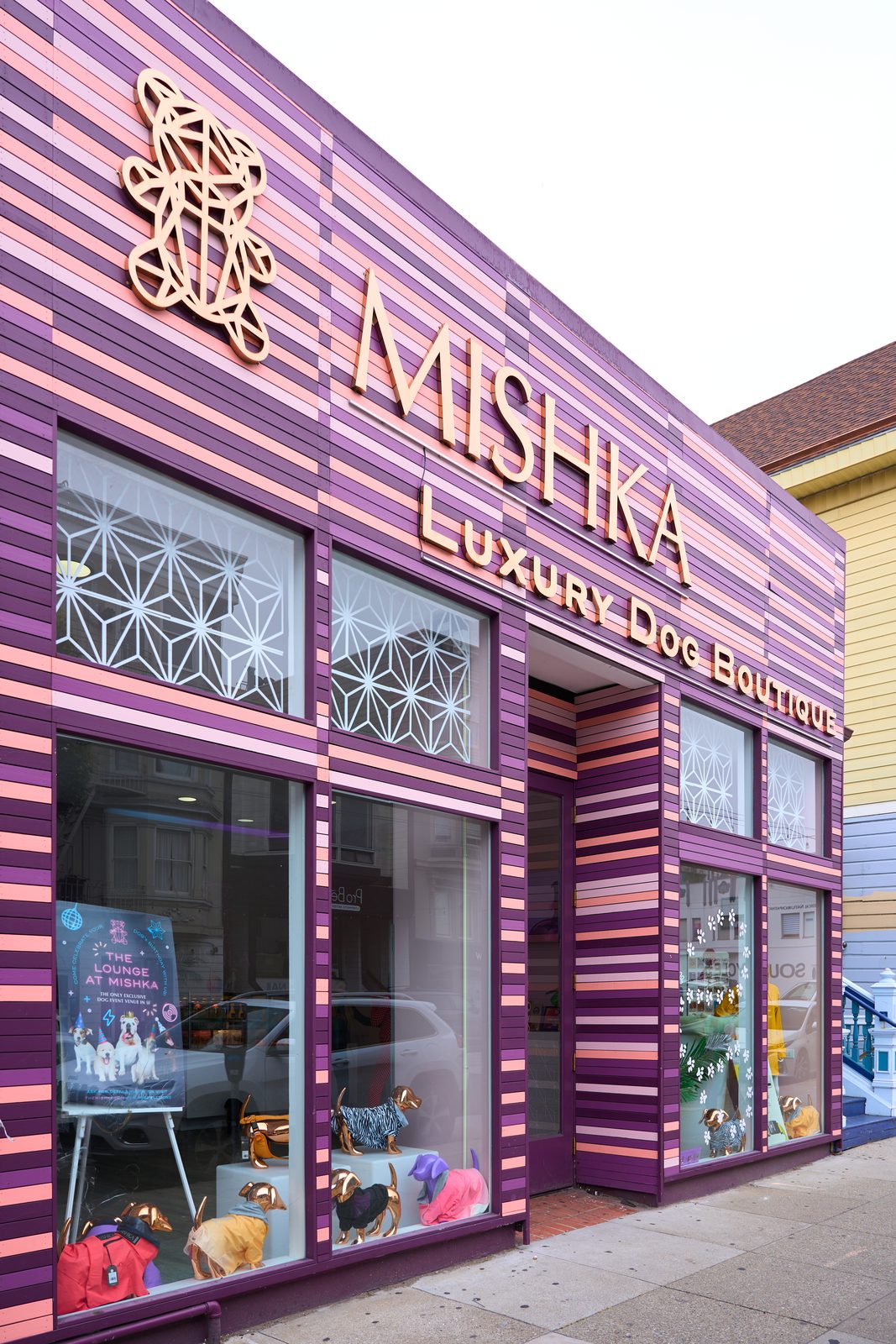 The MISHKA flagship on Union Street in the Marina, a storefront striped in plum and pink with the gold bear logo above the windows